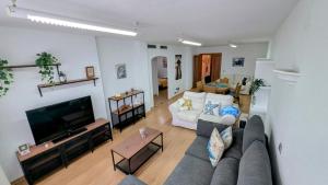un salon avec un canapé et une télévision à écran plat dans l'établissement Puerto de la Duquesa Sea Views, à Manilva