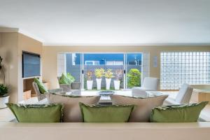a living room with a table and chairs at Gem with indoor jacuzzi in Cape Town
