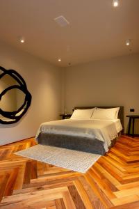 a bedroom with a large bed and a wooden floor at TEMA Relais - Tenuta Masciangelo in Francavilla al Mare