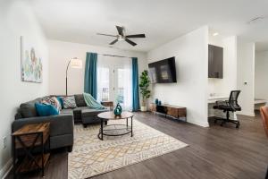 a living room with a couch and a table at Grandeur Unit Royal 103 in Whitestown