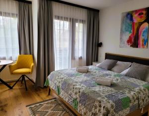 a bedroom with a bed and a table and a chair at Landhaus am Kurpark in Baden
