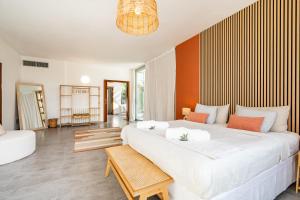 a bedroom with a large white bed and a living room at Can Toni in Sa Pobla +40 photos