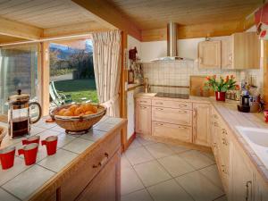 a kitchen with a bowl of oranges on the counter at Chalet J'Elage - OVO Network in Saint-Jean-de-Sixt
