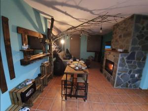 a living room with a table and a fireplace at Paraíso Desconocido 3. El Balcón del Espigüete in Cardaño de Abajo