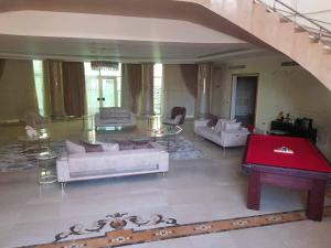 a living room with couches and a red table at فيلا مفروشه بالكامل in Madinaty