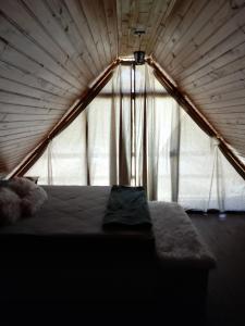 a bedroom with a bed in a tent at Pousada Vale das Pedras in Pedras Grandes