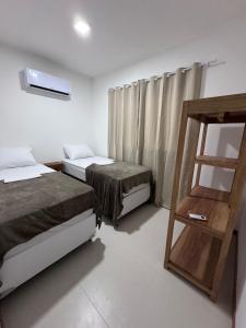 a room with two beds and a ladder in it at Residencial Ravena Arraial d'ajuda Casa 7 in Arraial d'Ajuda +33 photos