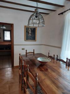 a dining room with a wooden table and a chandelier at La Casa de Dori in Beteta