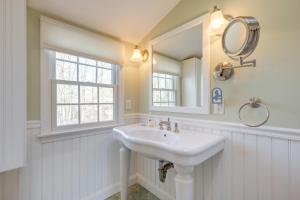 a white bathroom with a sink and a mirror at Close to Beaches Gem with Yard and Sunroom in Orleans in Orleans +27 photos