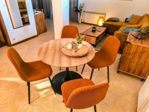 a table and chairs in a living room at Studio DeLuxe King with mountain view and spa rilski in Bansko