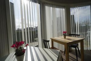 a dining room with a table and a large window at Apparthotel De Wielingen in Middelkerke