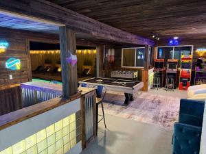 a room with a ping pong table and a billiards at Family Paradise Playhouse includes Pool and Gameroom in Dallas