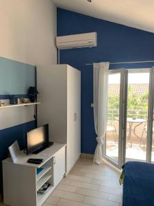 a room with a desk with a computer and a window at Apartment Patricia in Primošten