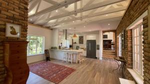 a kitchen and living room with a brick wall at Unique Hout Bay House in Hout Bay