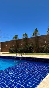 a swimming pool with a blue tiled floor at Wcasadepraia in Maragogi +15 photos