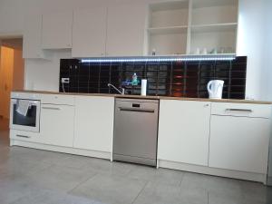 a kitchen with white cabinets and a counter top at TOPFLAT mit Küche I gratis Parkplatz I zwei Schlafzimmer I zentrumnah in Dortmund +20 photos