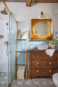 a bathroom with a sink and a mirror at Chatka na Roztoczu in Huta Lubycka