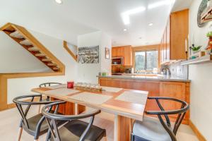a kitchen with a wooden table and chairs at 8 Mi to Lake Tahoe Spacious Northstar Condo! in Truckee