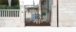 a wrought iron gate on the side of a building at Hotel Belvedere in Forte dei Marmi