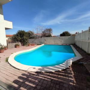 a swimming pool in a yard with a brick patio at Residenza Agnese Sardegna in La Ciaccia