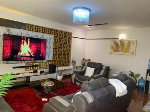 a living room with couches and a large fireplace at Makazi Homes in Nakuru