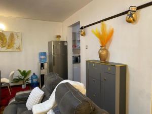 a living room with a couch and a refrigerator at Makazi Homes in Nakuru