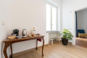a room with a wooden table with dishes on it at La SuiteDellAvvocato in Naples