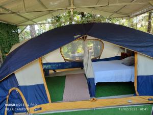 a tent with a bed inside of it at Villa Campo's in Venecia