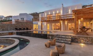 a villa with a swimming pool and a house at Ria Mar Villas & Suites by Live&Travel in Houlakia