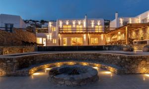 a house with a stone walkway in front of a building at Ria Mar Villas & Suites by Live&Travel in Houlakia