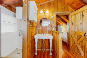 a bathroom with a white sink and a shower at The Cabin & Loft Fort Defiance in Pittsfield +56 photos