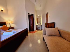 a living room with a bed and a couch at MyHavelock Town Studio Apt, with Own Pvt Gate Parking in Main City in Nawala +26 photos