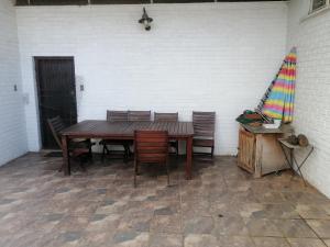 a wooden table and chairs sitting in a patio at HavenNest Guest House in Roodepoort