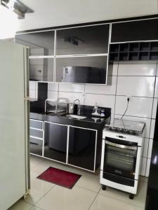 a kitchen with stainless steel cabinets and a stove at Prestige Loft in Contagem