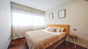 a bedroom with a bed and a large window at Desconectaengalicia Rincón de Cabodeiro in Isla de Arosa +30 photos