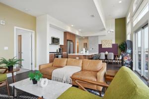 a living room with a couch and a kitchen at 2880 Skyline Penthouse at Espadin in Denver