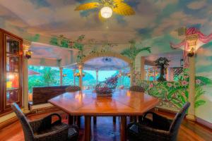 a dining room with a table and a painting on the wall at Hotel Cuna del Angel in Uvita