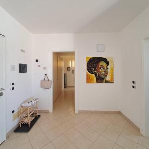 a hallway with a painting of a black man on a wall at Barlavento Residence Estoril beach - Sal Rei City in Sal Rei