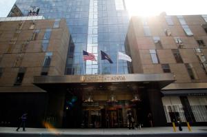 a building with american flags in front of it at InterContinental New York Times Square by IHG in New York