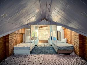 a bedroom with two beds in a room at The Elevia, Jibhi in Jibhi +49 photos