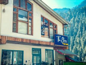 a building with a sign on the side of it at The Elevia, Jibhi in Jibhi