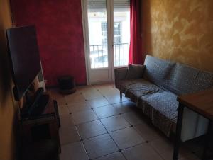 a living room with a couch and a television at Maison 2 faces Argeles Centre Ville WATCHTOWER in Argelès-sur-Mer