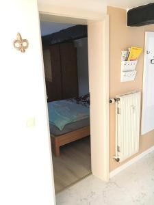 a bedroom with a bed through a doorway at Zweite Heimat Ferienwohnungen in Herdecke