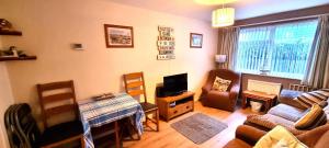 a living room with a couch and a tv at 9 Wheal Ramoth in Perranporth