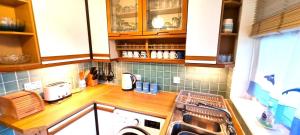 a kitchen with a sink and a dishwasher at 9 Wheal Ramoth in Perranporth