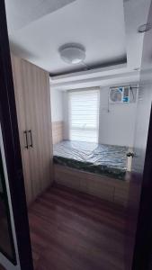 a room with a bed in a room with a window at Manila Condo Staycation in Manila