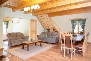 a living room with a table and a dining room at Két Patak Retreat in Bucsin