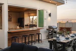 a patio with a bar and tables and chairs at Ventana Cove Pickleball Retreat in Yucca Valley