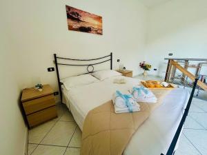 a bedroom with a bed with towels on it at La Dimora nel Cilento in Omignano
