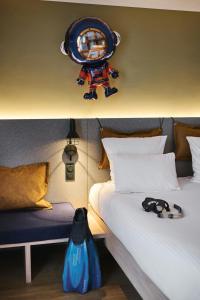 a room with a bed with a robot on top of it at Moxy Annecy in Annecy
